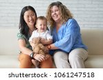 Happy multi-ethnic female couple with their adorable baby boy