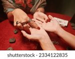 Small photo of Fortune teller pointing at life line and love line of client