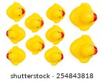 Small photo of Yellow rubber ducks in a row. An individualist is sticking out the crowd