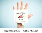 Marketing plan concept. Sticky note illustrated with a megaphone. Top five reasons. Open hand up holding speech bubble with message on blue background.
