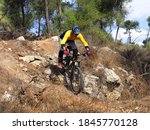 Mountain cyclist riding down a rocky slope. Mountain biking, Enduro.