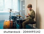 Young Blond Teen Boy Play Drum...