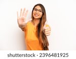 Small photo of asian pretty woman smiling and looking friendly, showing number six or sixth with hand forward, counting down