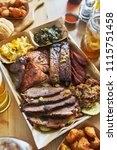 Small photo of texas style bbq tray with smoked brisket, st louis ribs, pulled pork, chicken, hot links, and sides