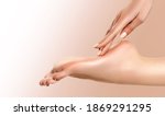 Small photo of Perfect clean female foot . Beautiful and elegant groomed girl's hand touches her feet . Spa ,scrub and leg care .