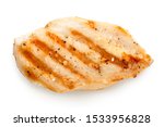 Whole grilled chicken breast with grill marks and ground black pepper isolated on white. Top view.