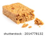 Partially eaten oat flapjack with nuts isolated on white. With crumbs.