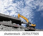Small photo of Hydraulic breaker hammer excavator at demolition work. Excavator, digger taking down building. Demolition of an old building. Complete demolition work of the building with hydraulic shears.