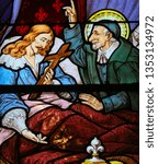 Small photo of Paris, France - February 10, 2019: Stained Glass in the Church of Saint Severin, Latin Quarter, Paris, France, depicting Saint Vincent de Paul at the Deathbed of King Louis XIII of France