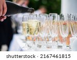 Waiter pouring champagne into glass