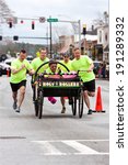 Small photo of LAWRENCEVILLE, GA - MARCH 29: A team of clergymen push a "Holy Rollers" bed in the Lawrenceville Bed Race, to benefit a local county homeless shelter, on March 29, 2014 in Lawrenceville, GA.