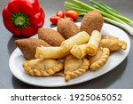 Small photo of Lebanese Plate of Kebbeh, cheese rolls and meat pie isolated on white