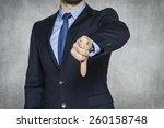 Businessman pointing thumbs down