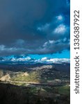 Small photo of Beautiful day landscape with a view of the city among the mountains against the blue sky and clouds. Italy.Enna. Vertical photo