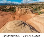 Small photo of Hoodoo On Slick Rock Overlooking The Straight Cliffs Formation at The Devils Rock Garden on The Kaiparowits Plateau,Devils Rock Garden, Grand Staircase Escalante NM, Utah, USA