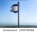 Partially Torn Israeli Flag Is...