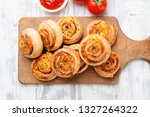 Rolls of puff pastry with bacon and cheese .