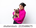 Young hispanic woman holding a dog isolated on white background smiling a lot