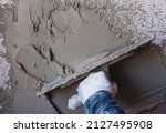 Small photo of Construction workers plaster the facade of the house. Worker plastering tool plaster marble on interior plaster rough