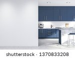 Interior of modern kitchen with white walls, concrete floor, blue countertops and cupboards, marble bar with stools and white mock up wall on the left. 3d rendering