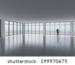 Silhouette of businessman against panoramic office window 