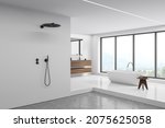 Small photo of Corner view on bright bathroom interior with bathtub, shower, panoramic window, concrete floor, white walls, mirror, sink and sideboard. Concept of hygienic and spa procedures. 3d rendering
