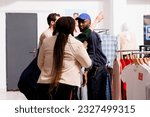 Black Friday madness. Rude aggressive people fight with fashion store security while waiting for sales, stressed African American security guard controlling entrance of shopping mall
