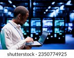 Small photo of Programmer typing cloud computing service business disaster contingency plan on laptop to provide quick restoration of service, limiting downtime and minimizing interruptions to server hub operations