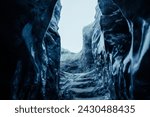 Small photo of Big ice rocks inside glacier crevasse, transparent vatnajokull ice caves in icelandic landscapes. Spectacular frozen icebergs on wintry polar weather, melting icy blocks with cracked structure.