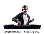 Young stylish man in glasses posing behind mixing console on white studio background.