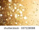 Christmas gold background. Golden holiday glowing abstract glitter defocused background 
