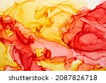 Abstract red yellow watercolor background. Paint stains and wavy spots in water, luxury fluid liquid art orange wallpaper