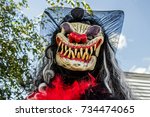 Small photo of Scary Monster with Sharp Teeth, Long Straggly Hair and a Red Nose