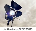 Small photo of A HMI lamp in the cloudy sky for professional film lighting