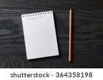 shopping list phrase in notepad on gray wood table