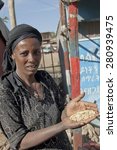 Small photo of DEBARK, ETHIOPIA - DECEMBER 30: Unidentified Ethiopian woman checks stocks of teff on December 30, 2013 in Debark, Ethiopia. Teff is the main subsistence crops in Ethiopia.