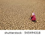 Sad man sitting on dry ground .concept hope and drought