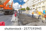 Installing concrete plates by crane at road construction site timelapse hyperlapse. Industrial workers with hardhats and uniform. Reconstruction of tram tracks in the city street