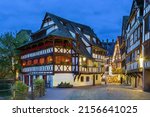 Small photo of Street with historical half-timbered houses in Petite France district with Maison des Tanneurs (tanners house), Strasbourg, France. Evening