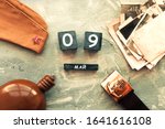 Small photo of Flask, cap, soldier belt with a five-pointed star with a hammer and sickle. old photographs of the war years and a wooden calendar with the date May 09. Victory Day .Russian text on May 9