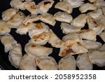 Small photo of Traditional Polish dish -pierogi ruskie. Pierogi are fried in a pan.