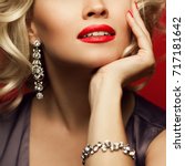 Small photo of Girl's best friends and femme fatale concept. Marilyn Monroe style. Close up portrait of rich woman smiling wearing expensive luxurious diamond bracelet, earring. Studio shot