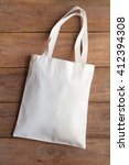 White Fabric Bag On Wooden...
