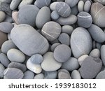 Pebbles background, abstract background with round gray stones,


