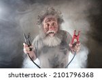 Suprised old man with beard holding jumper cables surrounded by smoke 