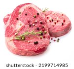 Two fresh ribeye steaks with peppercorn and rosemary isolated on white background. Closeup. 