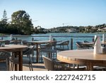Small photo of Table and chairs from a beach bar restaurant near a lake in Ria Formosa region, located in Quinta do Lago, Portugal.