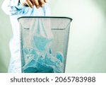 Small photo of Man is throwing surgical mask to the bin ,insanitary concept in studio Chiangmai Thailand.