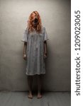 Small photo of Scary ghost woman in nightgown with knife / halloween, zombie concept