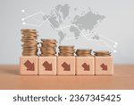 Small photo of For economic crisis, Inflation. The recession of the economy. Stacks of coins with down arrow on wooden cube blocks and world map background